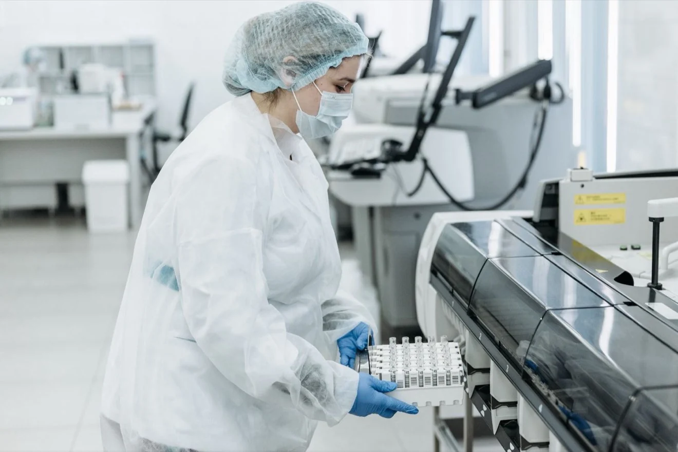 Technician working beside packing machinery in the plant